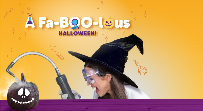 A mad science instructor wearing a witch hat using the mad science smoke shower machine over a black pumpkin.