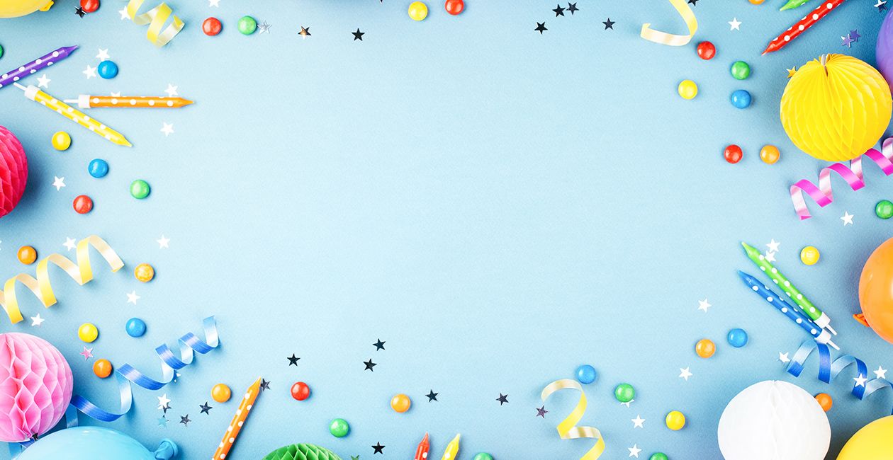 Birthday party blue background. Frame made of colorful serpentine, balloons, candles, candies and confetti.